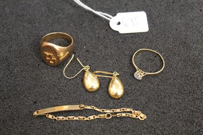 two gold rings, a bracelet, a ring, and a bracelet with a tag