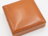 brown leather wallet on a white surface with a white background