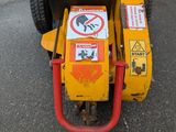 a small yellow machine that is parked on the street