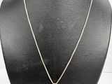 a necklace with a circular pendant on a mannequin neck