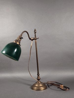 an antique brass desk lamp with a green glass shade