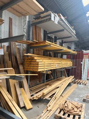 many pieces of wood stacked on the shelves in the warehouse