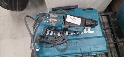 a blue drill sitting on top of a blue box