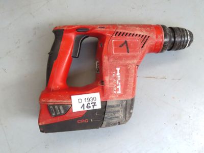 an image of a red corded drill is laying on the floor