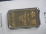 a gold bar that is sitting on top of a piece of paper