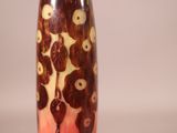 a vase that has a brown and white design on it