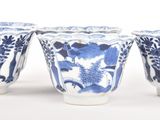 three blue and white vases sitting on top of a white table