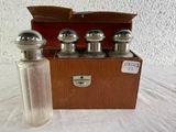 four bottles of perfume sitting next to a wooden box