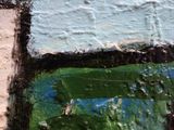 a close up of a painting of a cross on a wall