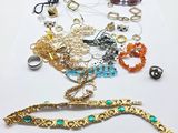 many different types of bracelets and rings on the table