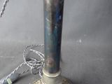 a silver candle that is sitting on a table
