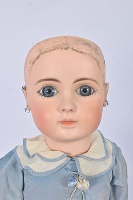 a doll that is wearing a blue dress with a white collar