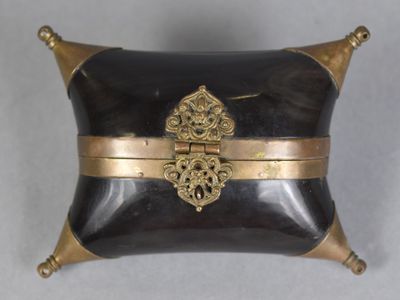 a black and gold box with a gold decoration