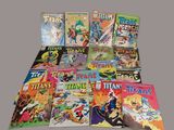 many comic books are stacked on top of each other on a table