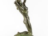a bronze statue of a woman holding a flower in her hands
