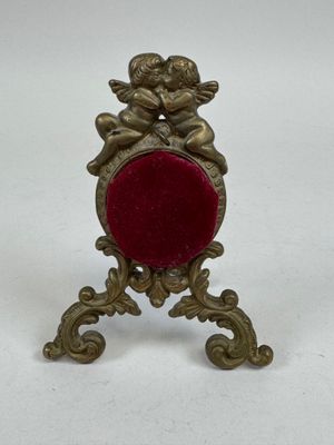 a close up of a small red object on a white surface