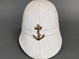 an old white helmet with a gold anchor on it