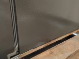 a picture of a refrigerator with a door open on a wooden floor