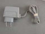 a gray charger that is plugged into a wall charger