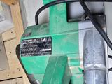 a green machine that is sitting in a garage