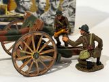 two figurines of a man and a cannon on a table