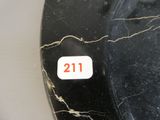 a black and white clock with a red number on it