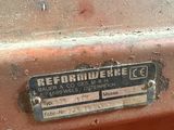 a rusted metal sign on the side of a rusted car