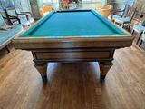 a pool table in the middle of a living room