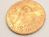 an image of a gold coin sitting on top of a white surface