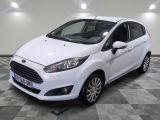 the white ford fiesta is parked in a room with a checkered floor