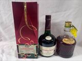 three bottles of liquor sitting next to each other on a table
