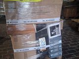 boxes stacked on top of each other on a pallet on a brick floor