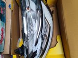 the headlight of a car is in a box on the floor
