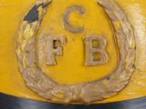 a yellow fire hydrant with a black ribbon around it