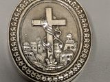 silver plated cross pendant with jesus on the cross on it
