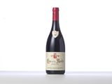 a bottle of red wine sitting on top of a table