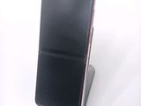a cell phone that is sitting on top of a stand