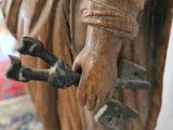 a statue of a man holding a bird on a table