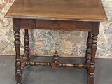 a small wooden table with a drawer on top of it