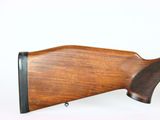 an old rifle with a wooden stock and a black handle