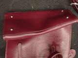 a purse that is sitting on the floor next to a pair of glasses