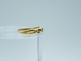 a gold ring sitting on top of a clear glass