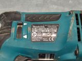 a close up of a corded drill on a table