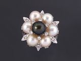 une broche en forme de fleur, composée d'une perle noire et de diamants