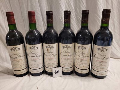 six bottles of red wine are lined up on a table