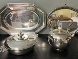 a silver tea pot and a silver teapot on a table