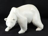 a white bear figurine on a black background