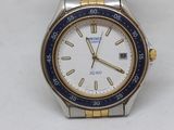a watch that is sitting on a white surface