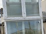 two windows that are on a pallet in front of a building