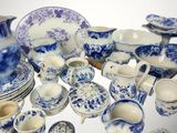 a lot of blue and white dishes and cups on the table